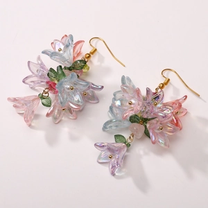 Iridescent lily flower drop earrings with white pearls and gold hooks detail