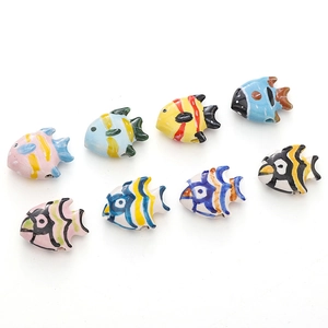 Detailed view of colorful hand-painted ceramic tropical fish beads for DIY jewelry making