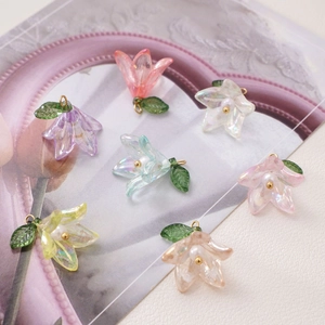 Detailed macro view of colorful acrylic lily flower charms with iridescent pearl finish