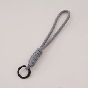 Detail of grey braided paracord lanyard with a black circular spring metal buckle