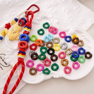 Detail of colorful acrylic beads and woven red lanyard with smiley heart pendant
