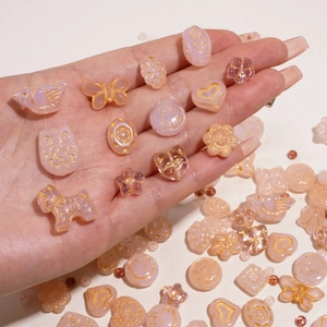 Pink translucent Czech glass beads with gold accents in various animal and heart shapes
