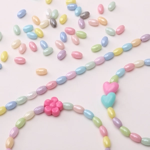 Mix of colorful pastel rice beads, flower and heart charms for DIY jewelry making