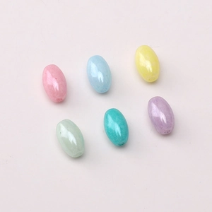 Detail view of 4x7mm oval glass beads in pastel cream colors for DIY jewelry making