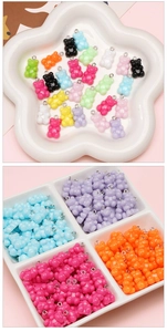 Macro view of colorful acrylic gummy bear charms with silver metal rings for DIY jewelry