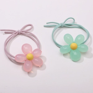 Detailed macro view of pink and green resin tulip flower hair ties with elastic cords