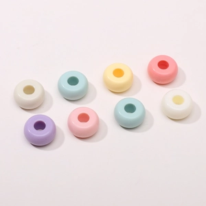 Macro detail of acrylic macaron ring beads for DIY jewelry and phone chain making