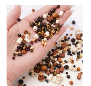 Macro shot of natural wood beads in various shapes and earthy colors for DIY jewelry making