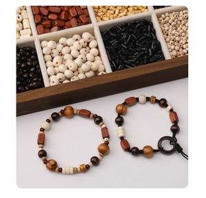 Detail of handcrafted wooden beaded bracelets set with various natural brown and white beads
