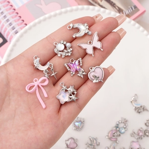 Pink enamel and silver alloy charms set featuring butterfly, moon and heart shapes