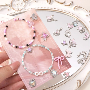 Pastel beaded bracelets set with butterfly and star pendants on a vintage mirror base
