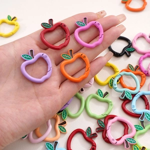 Macro shot of colorful apple-shaped metal spring hooks for handmade DIY jewelry