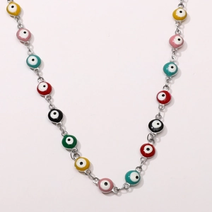 Macro detail of colorful enamel evil eye charms on a silver stainless steel chain link