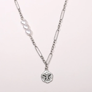 Detail of silver necklace chain with heart pearls and retro butterfly pendant