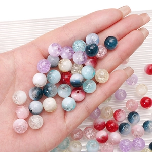 Vibrant cracked glass round beads for DIY jewelry making displayed in palm of hand