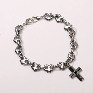 Silver heart-link chain jewelry with a black zircon cross pendant and lobster clasp detail