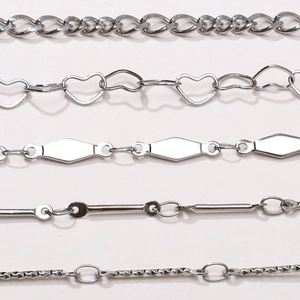Detailed close-up of five silver stainless steel chain styles for DIY jewelry making