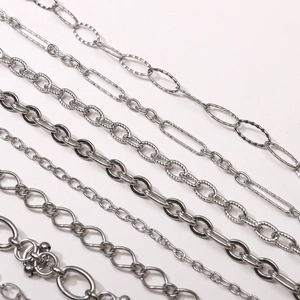 Macro detail of various stainless steel DIY jewelry chains in polished silver finish