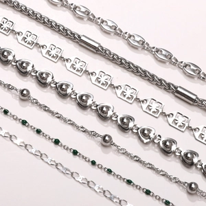 Detailed macro view of various stainless steel chain styles for DIY jewelry making