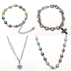 Stainless steel jewelry set featuring evil eye beads, heart links, and butterfly pendants