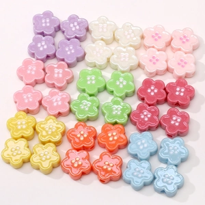 Macro detail of colorful acrylic flower buttons with four holes for DIY jewelry making