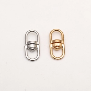 Close-up of gold and silver 360-degree rotating alloy D-ring metal buckles and hardware