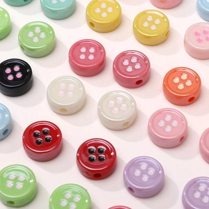 Macro shot of colorful acrylic flower button beads showing threaded side holes for DIY crafts