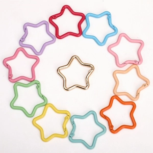 Set of 11 colorful star-shaped alloy carabiner keychains arranged in a circle on white