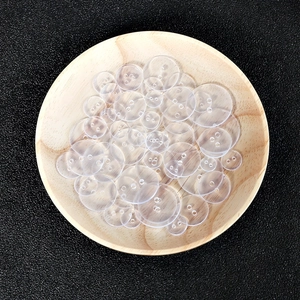 Clear round plastic buttons in various sizes with two and four holes for DIY sewing