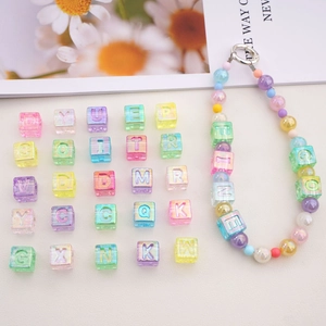 Macro detail of aurora colorful acrylic cube letter beads and DIY handmade keychain