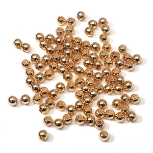 Detailed view of polished golden metal spacer beads for DIY jewelry and bracelets