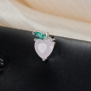 Macro shot of a pink heart gemstone apple stud earring with a green marquise leaf