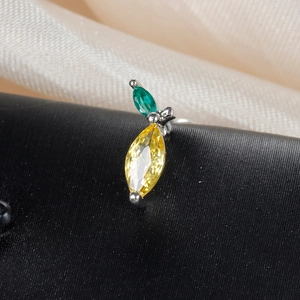 Macro shot of fruit-shaped stud earring with yellow and green marquise-cut gems
