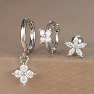 Detailed view of silver flower earring set featuring zircon studs and floral hoop pendants