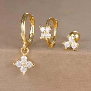 Close-up of gold flower earrings set featuring 925 sterling silver and zircon stones