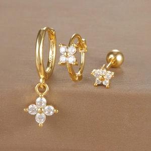 Macro view of S925 engraved gold floral earrings with zircon stones and polished finish