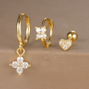 Detailed view of 925 sterling silver gold earrings set with zircon clover and heart studs