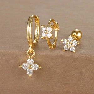 Macro detail of gold S925 silver earrings set featuring sparkling flower zircon stones
