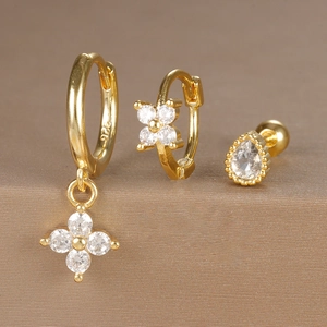 Macro detail of gold S925 silver earrings set with zircon flowers and pear drop