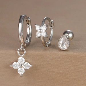 Macro shot of silver zircon earring set with flower charms and water drop studs