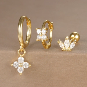 Macro detail of three-piece gold-plated S925 silver earrings set with zircon stones