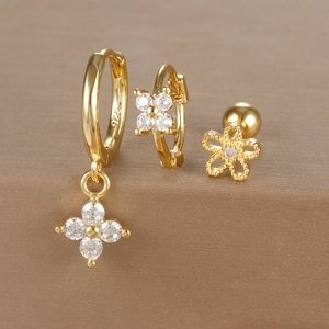 Detailed close-up of gold floral earrings set with micro-pave cubic zirconia on S925 silver