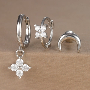 Close-up of a 3-piece silver earring set with floral zircon pendants and crescent stud