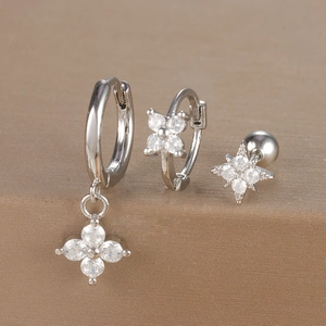 Macro detail of three-piece silver stud earring set with micro-paved cubic zirconia flowers