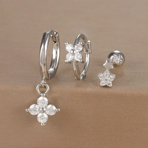 Detail of silver geometric floral earrings and star ear studs with sparkling cubic zirconia
