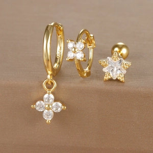 Detailed close-up showing S925 hallmark on gold clover earrings and star stud set