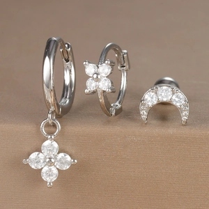 Detailed view of silver hoop earring set with zircon flower charms and crescent moon stud
