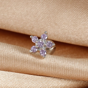 Macro view of flower-shaped stud earring with purple zircon and screw back closure