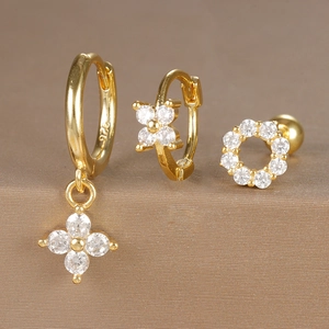 Detailed view of three-piece gold floral earring set with 925 stamp and cubic zirconia