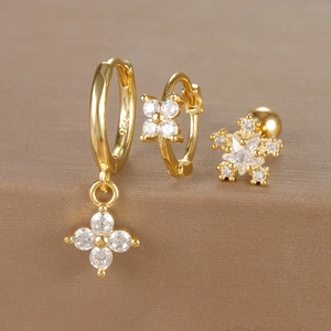 Macro shot of S925 stamped gold earrings set with micro-inlaid zircon floral details